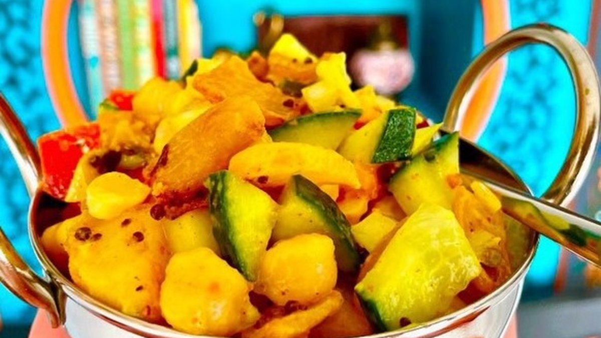 a shiny copper dish with handles containing a medley of vegetables at Mowgli's Tiffin in St. Pete