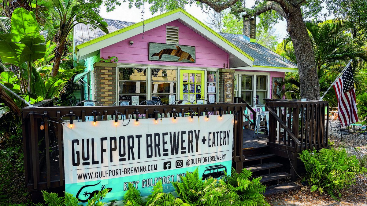 exterior of gulfport brewery showcasing outdoor deck and colorful building.