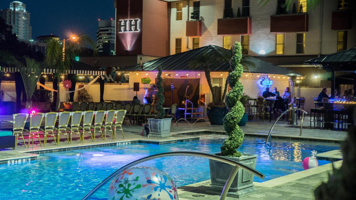 a view of the pool at the Hollander Hotel, softly lit at dusk