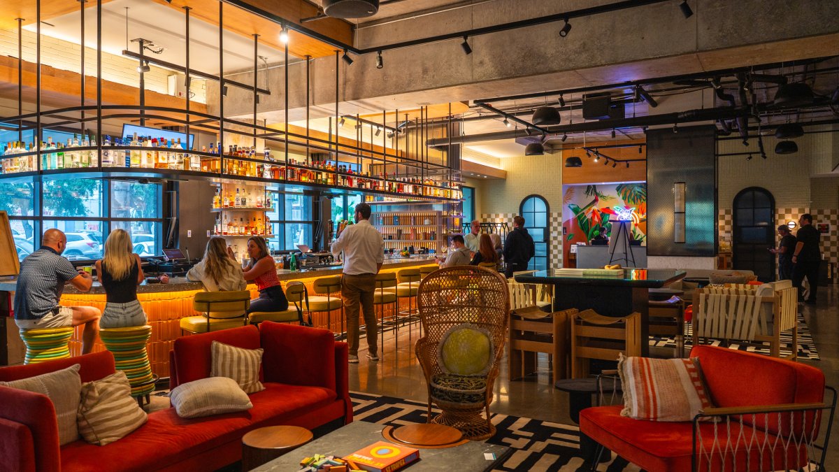 a boldly colorful lounge and bar area inside the Moxy Hotel St. Pete