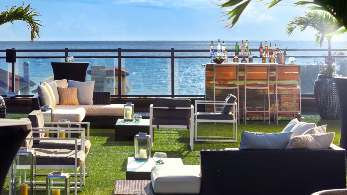 a view of the sparkling blue Gulf from a stylish rooftop bar at Hotel Zamora