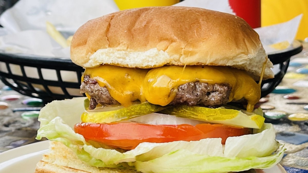 a juicy cheeseburger with tomato, lettuce, onion and pickles at El Cap in St. Pete