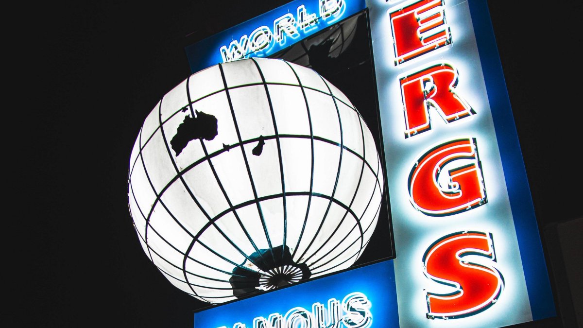a large lit up globe next to the words World Famous Ferg's