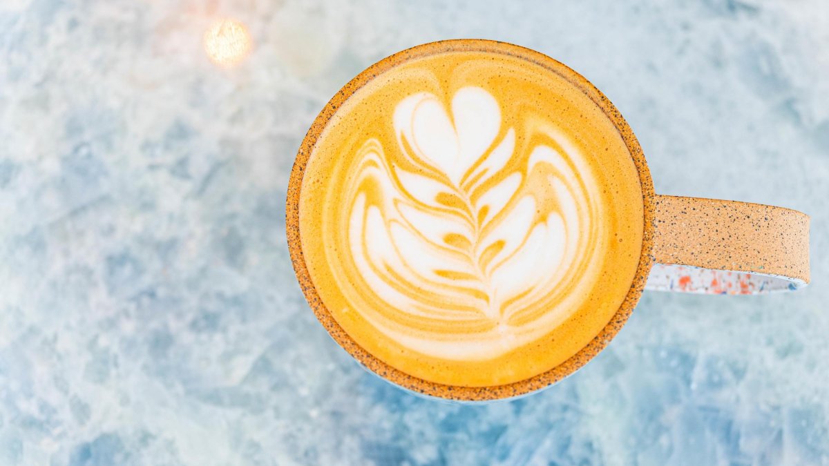 a view of a mug of hot latte with a delicate design
