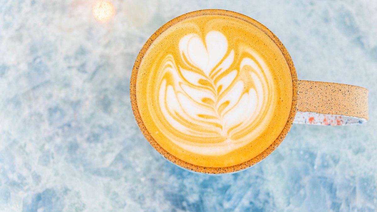 a view of a mug of hot latte with a delicate design
