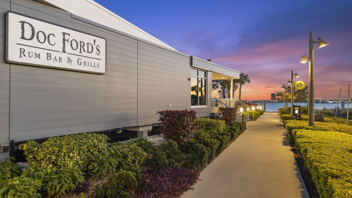 the exterior of Doc Ford's Rum Bar & Grille with Tampa Bay in the distance