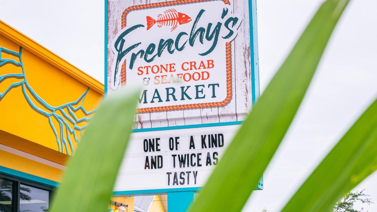 the sign outside Frenchy's Stone Crab & Seafood Market, saying "one of a kind and twice as tasty"