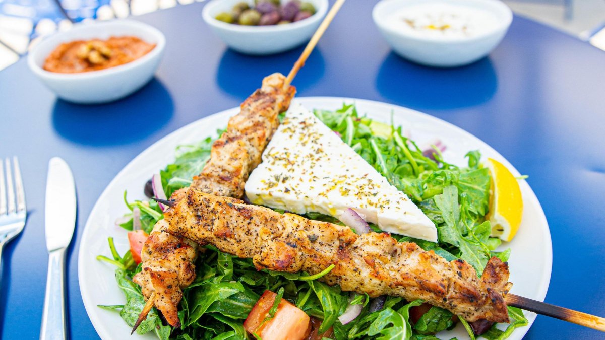 chicken skewers atop a greek salad at Baba on Central in St. Pete FL