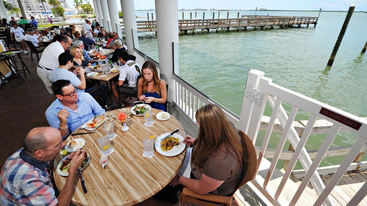 A waitress pours wind during a dinner cruise