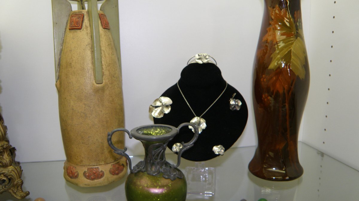 An Art Deco Austrian Vase, Bohemian Art Glass Vase and antique jewelry on display