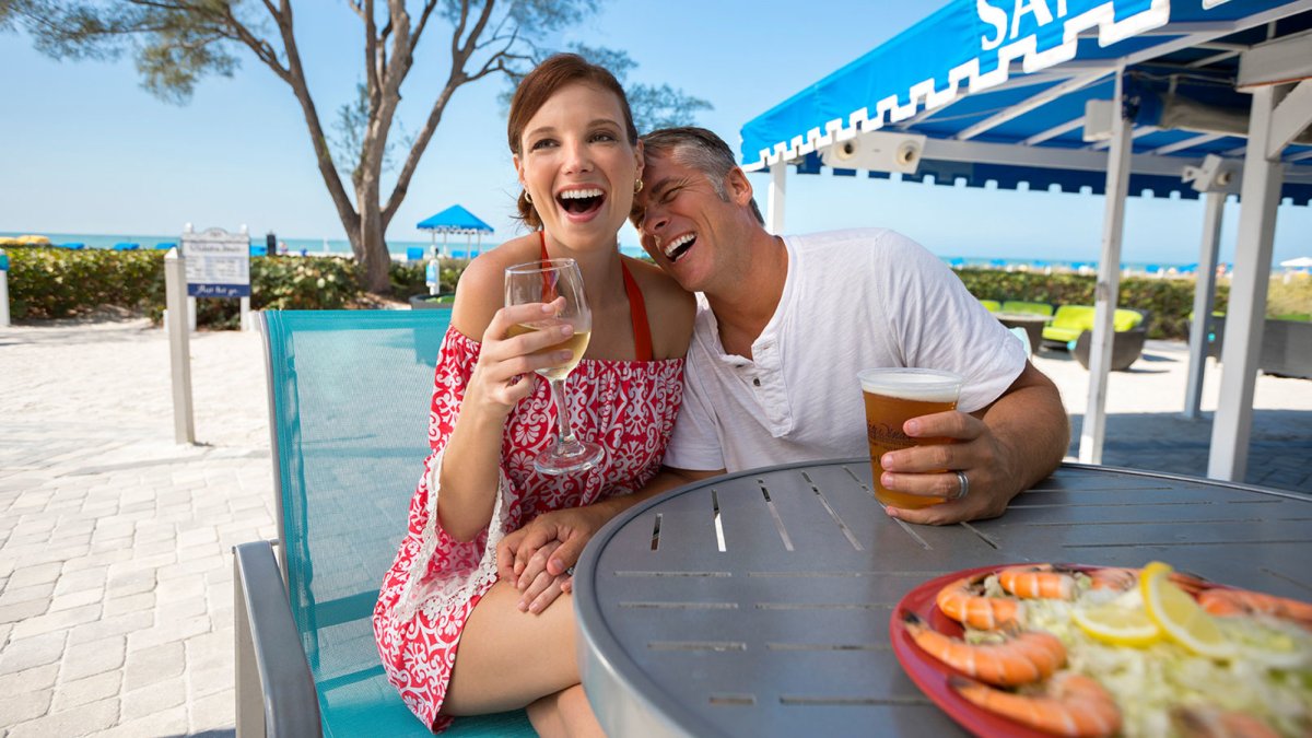 Sip on a drink with your toes in the sand at the popular SandBar.