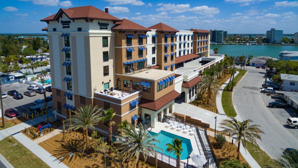 Exterior view shows the great pool and bay views.