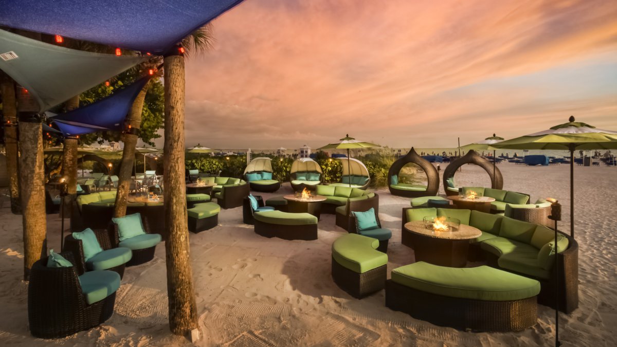 Sip on tropical drinks and listen to live music at Salty's Tiki Bar and beach lounge