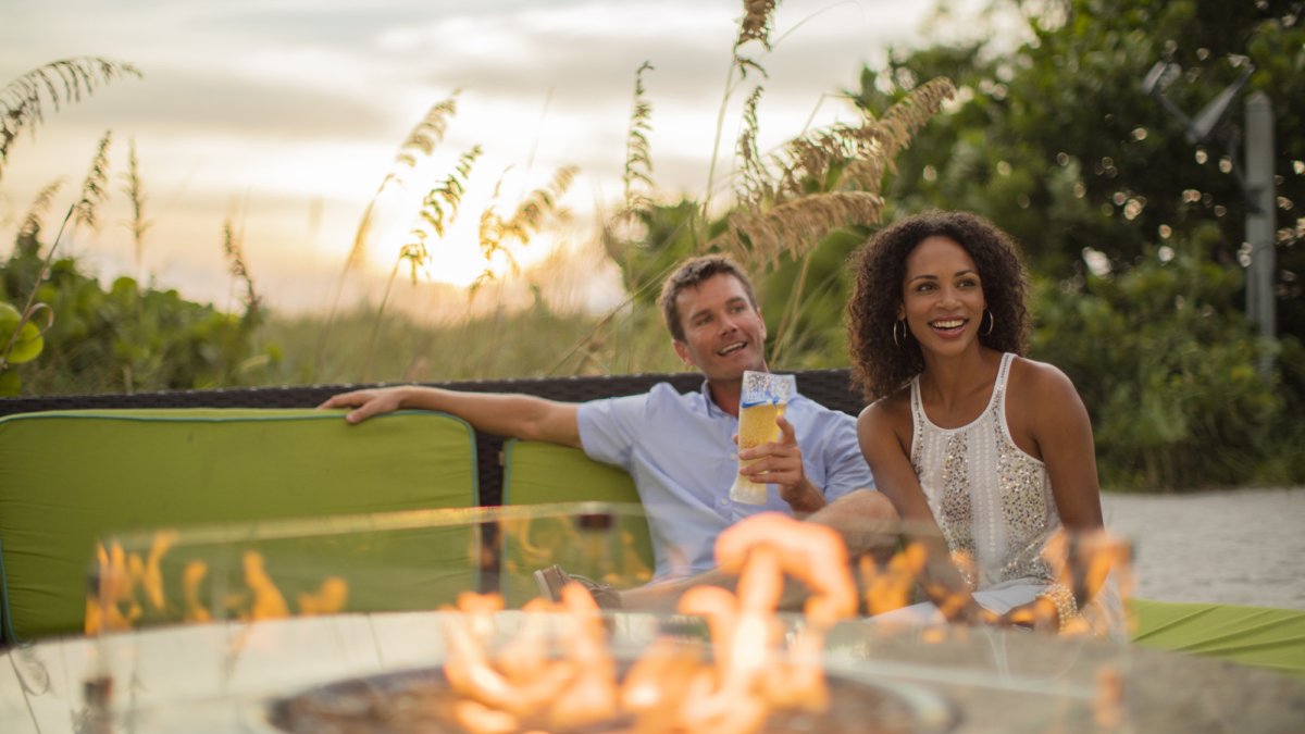 Relax around open fire tables at The SandBox Beach Lounge