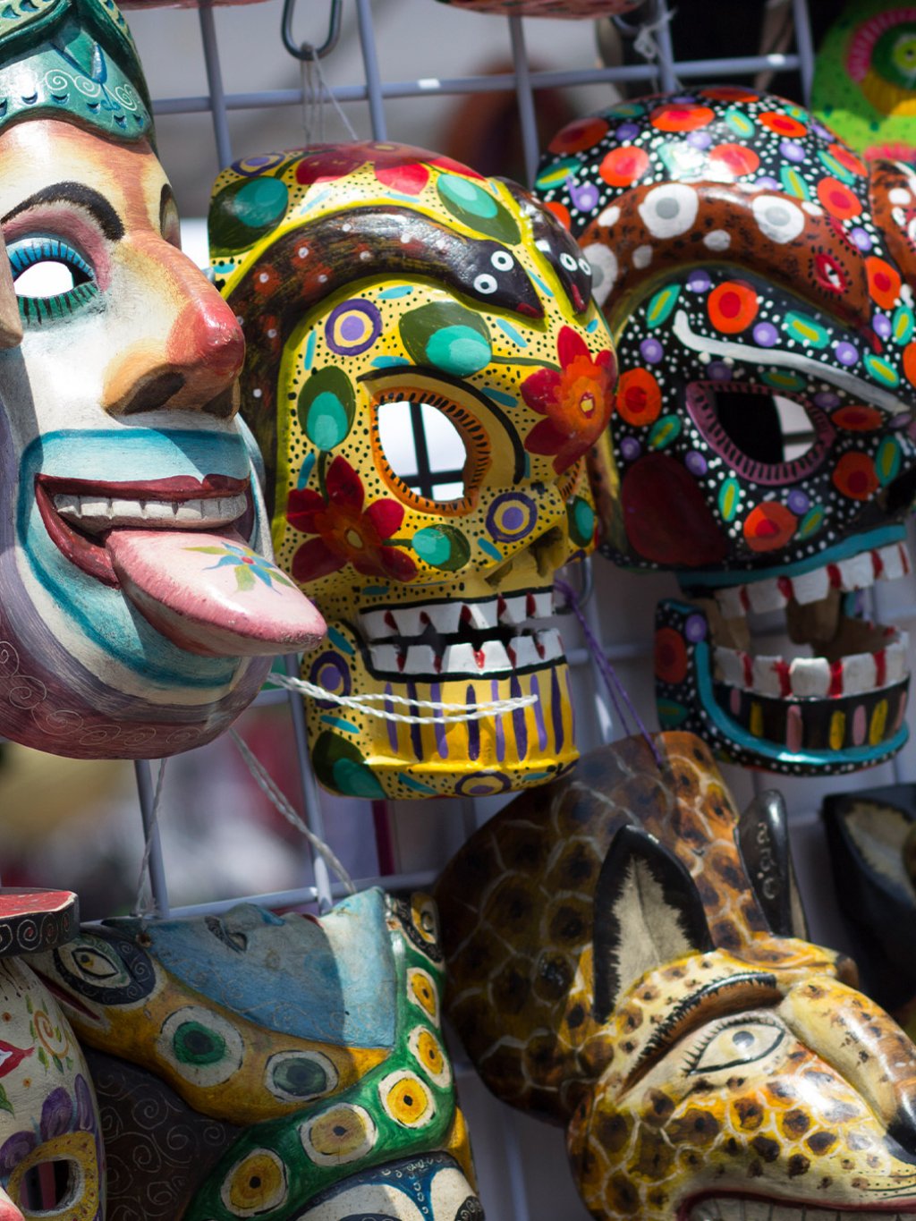 colorful, intricately painted masks for sale at a festival in Gulfport