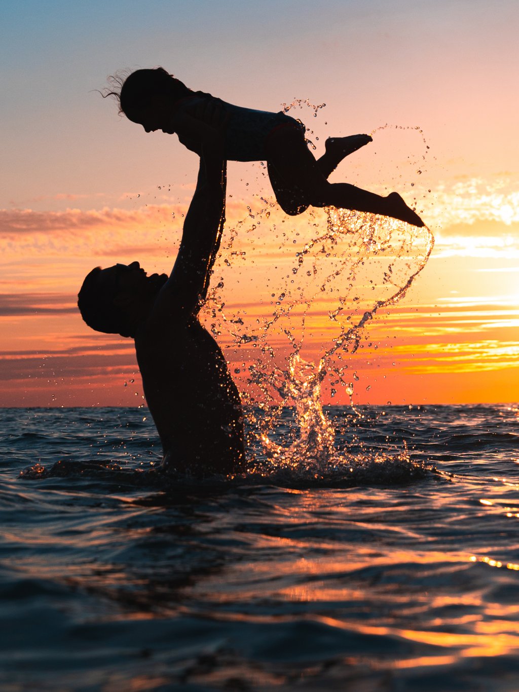 Father and daughter playing at Redington Beach during beautiful sunset