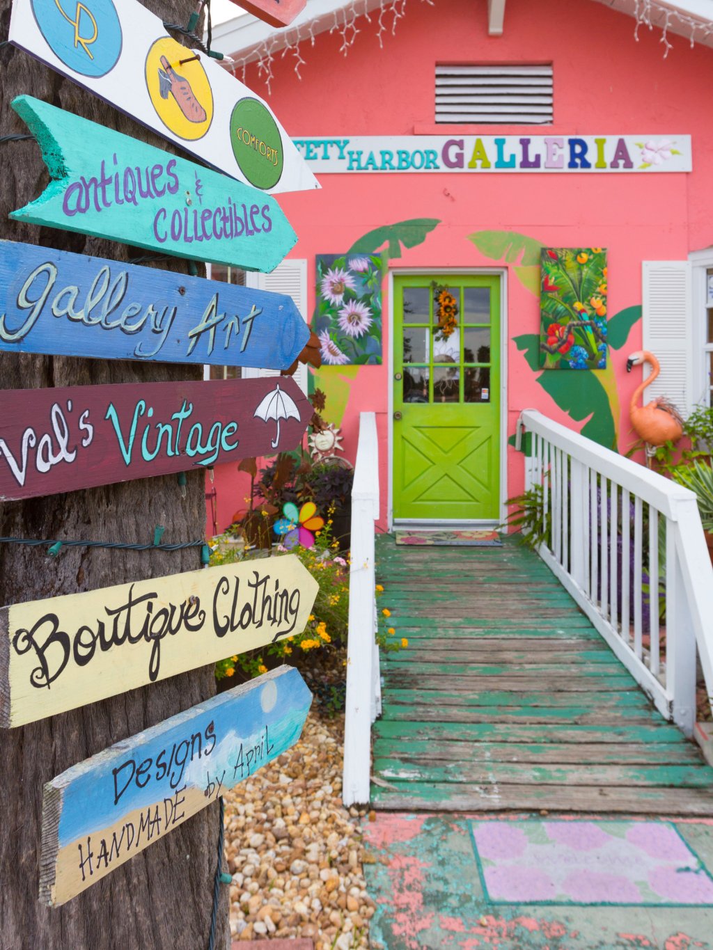 Colorful signs point to the front of the pink-painted Safety Harbor Galleria