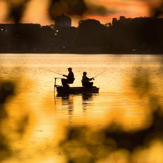 Silhouette of two men fishing at the Seminole Lake during sunset