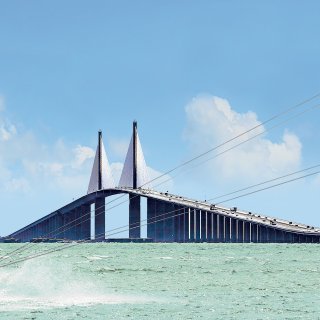A man kiteboards at the Skyway Bridge
