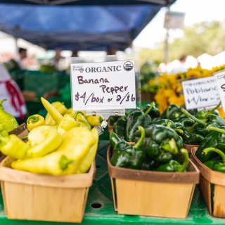 Baskets of organic peppers for sale at the St. Pete Saturday Morning Market