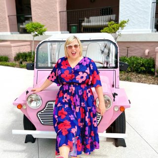 woman standing in front of pink car