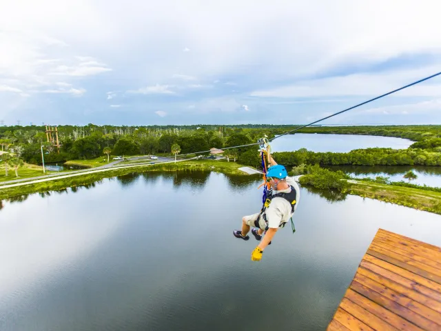 A man descends a zip line at Empower Adventures