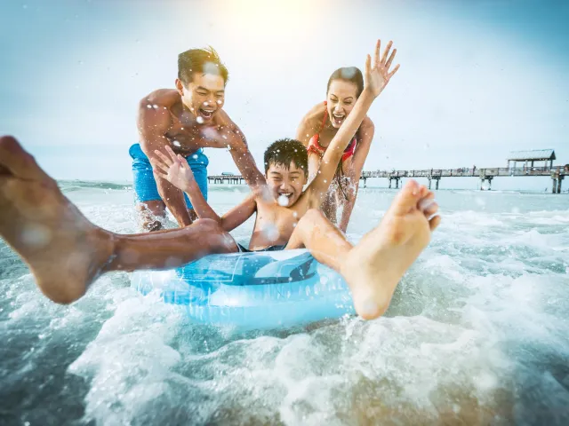 A family plays in the water near Pier 60 in Clearwater Beach, Florida