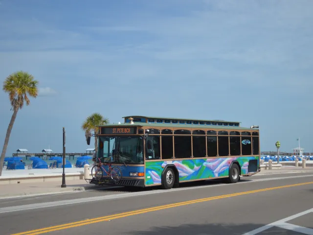 An image of the Suncoast Beach Trolley stopped in front of beach.