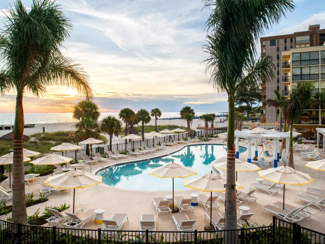 The pool at Sirata Resort with a view of St. Pete Beach horizon during sunset