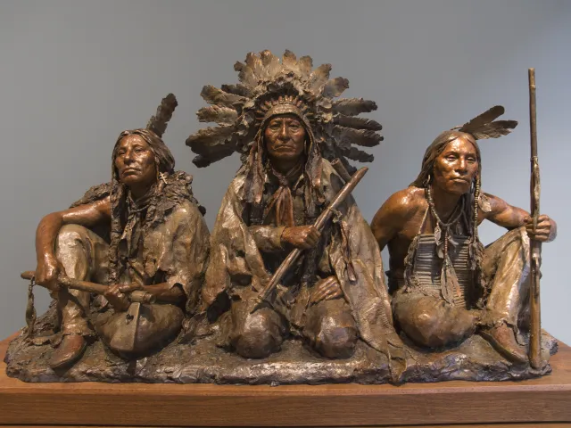 A bronze sculpture of Native American warriors