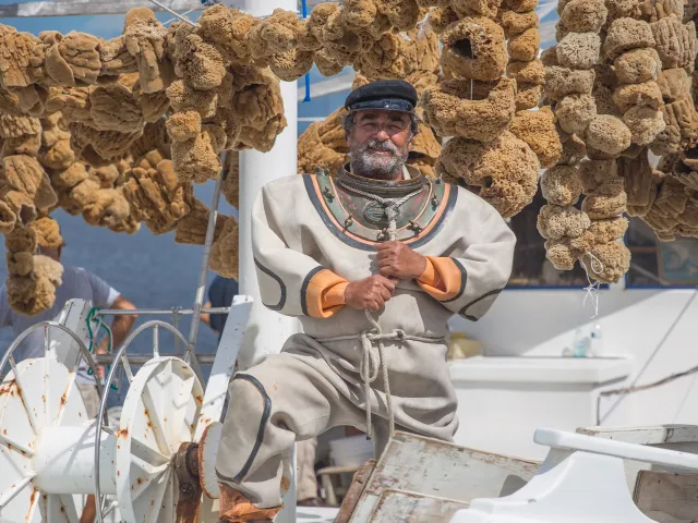 A sponge diver in a boat with lots of sponges in Tarpon Springs.