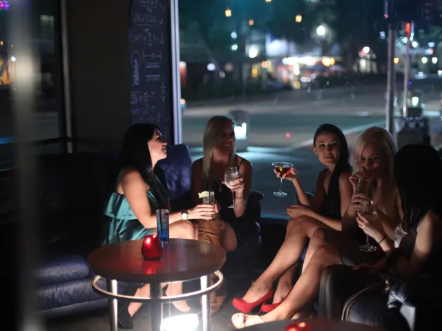 A group of woman talk over cocktails at a bar in downtown St. Pete