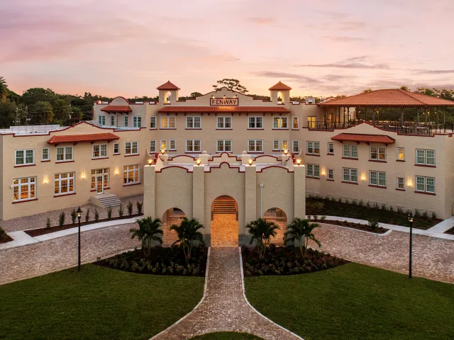 An aerial view of a large hotel at sunrise