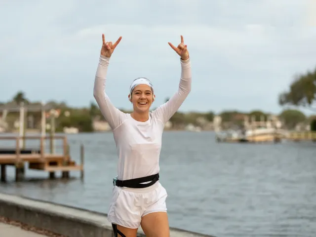 a young woman runs next to Coffee Pot Bayou during the St. Petersburg Distance Classic