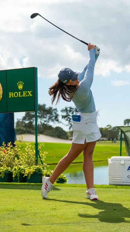 a female golfer takes a swing at The Annika tournament
