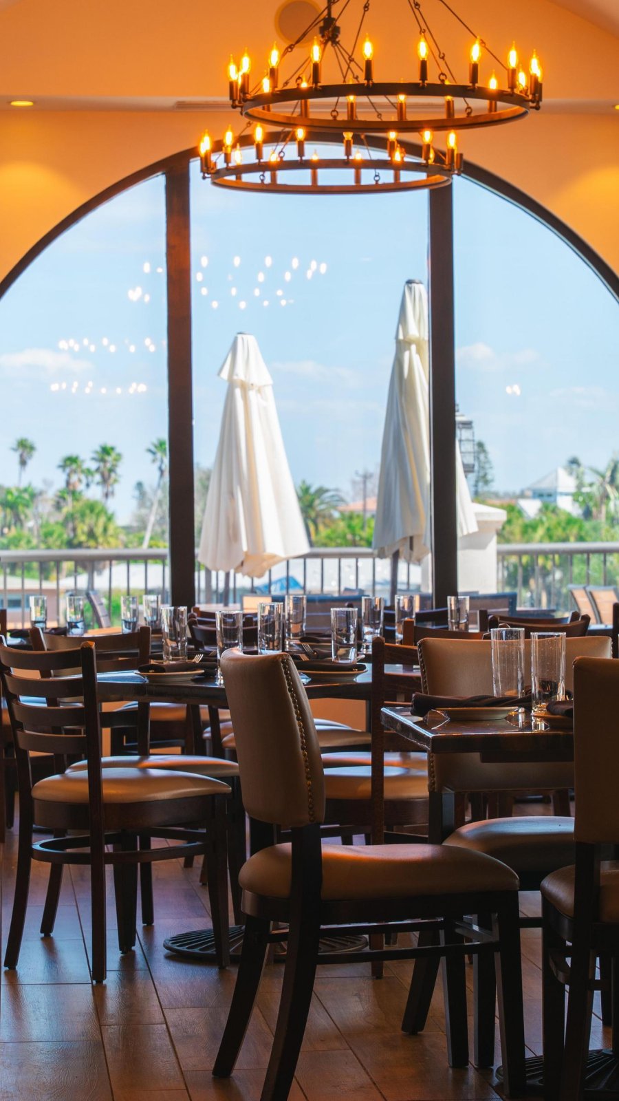 large half moon window with tables and chairs overlooking view out windo at hotel zamoras indoor restaurant