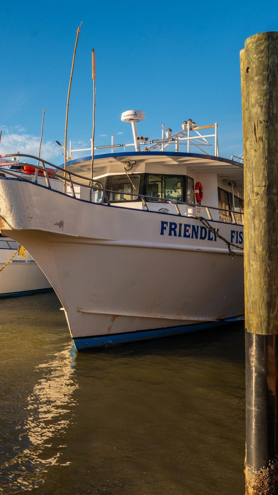 boat next to piling docked at pier