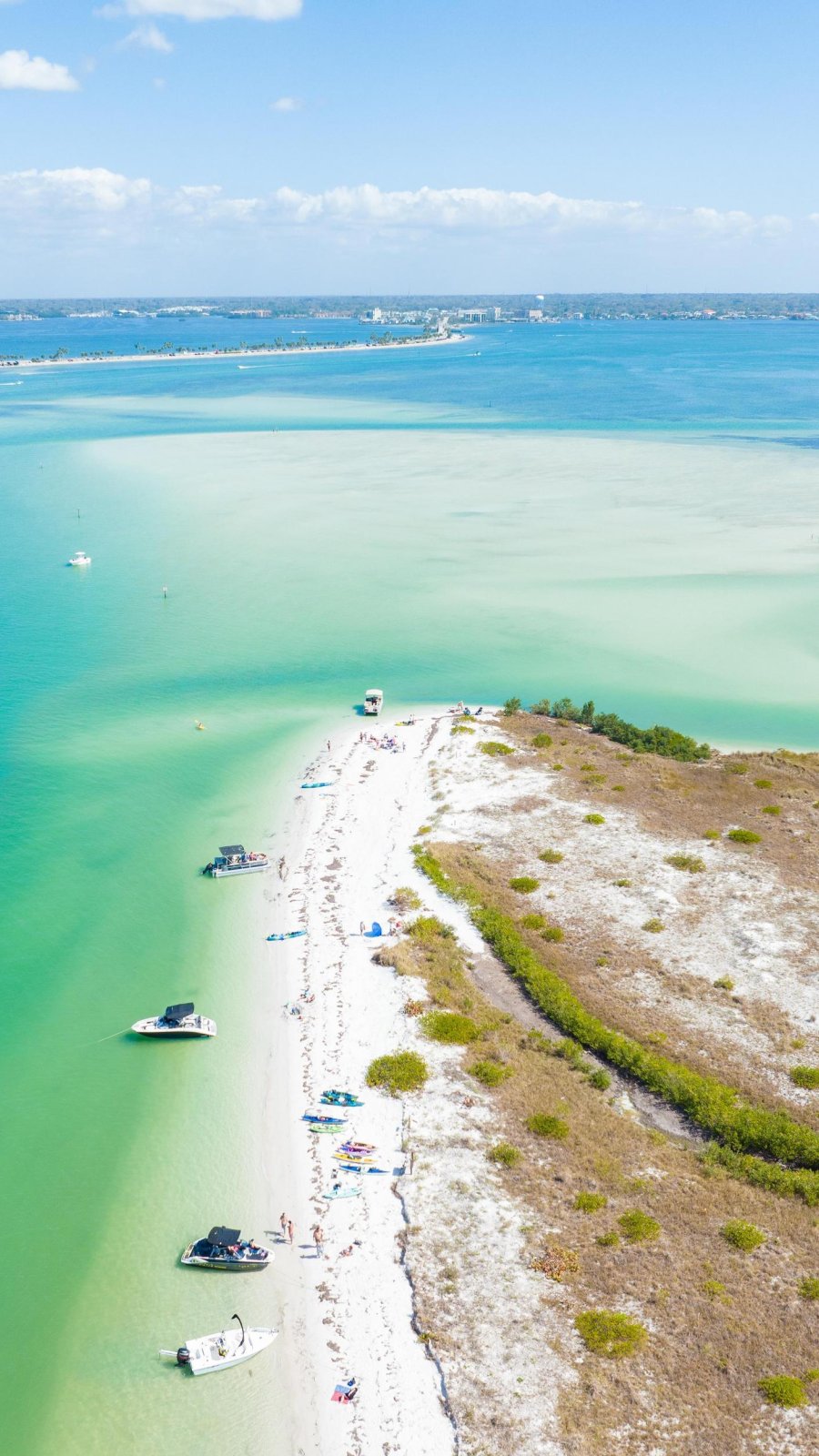 a drone shot of pristine Caladesi Island State Park, with boats anchored near a white-sand beach