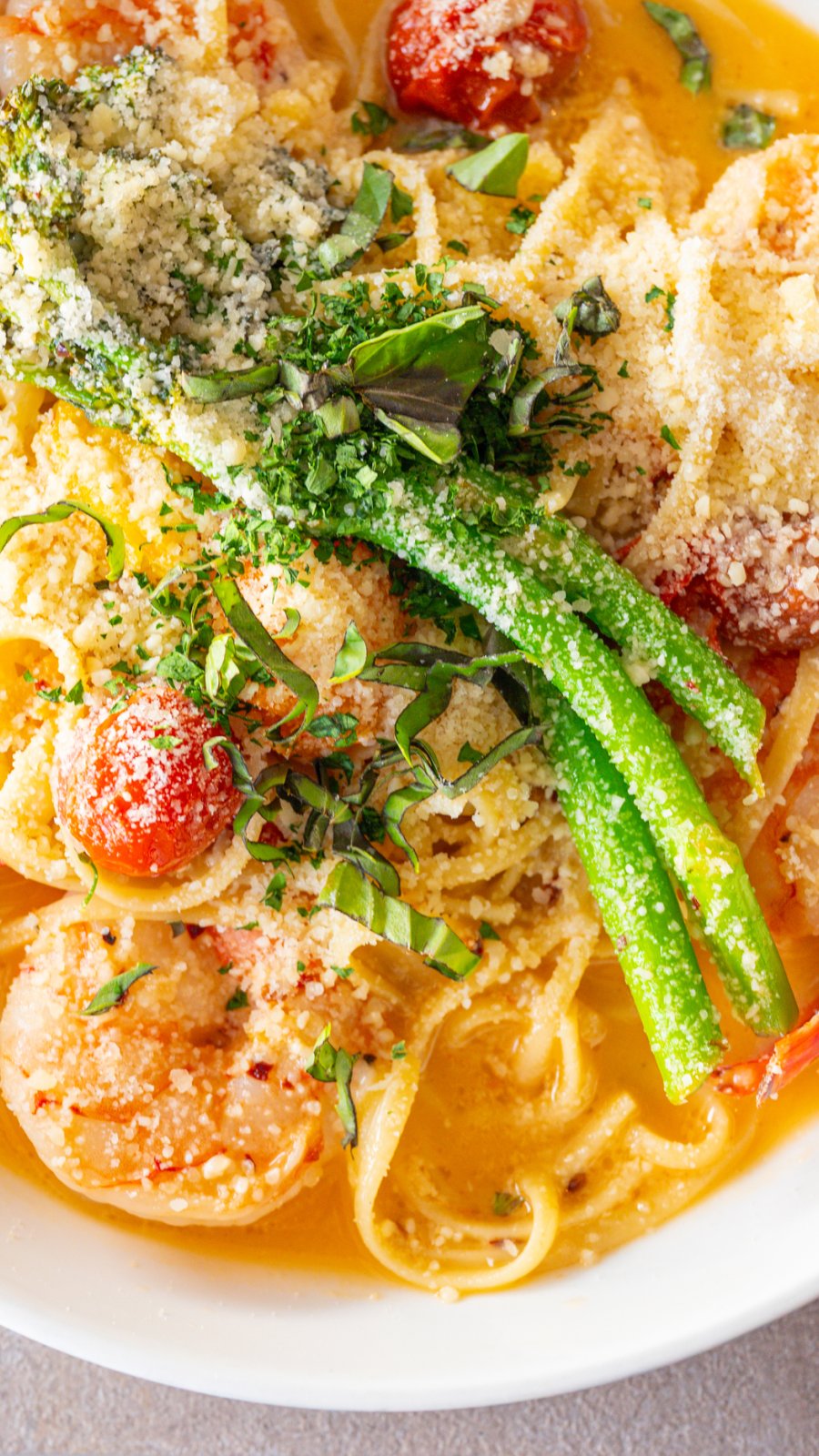 a plate of shrimp scampi with pasta and asparagus at Grace restaurant on St. Pete Beach