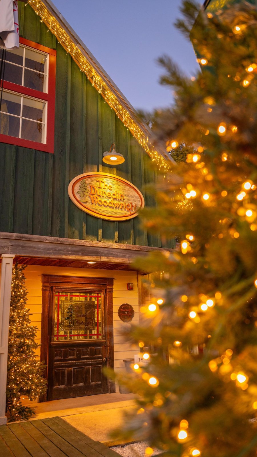 the exterior of the Woodwright Brewing Co. decorated for the holidays with Christmas trees