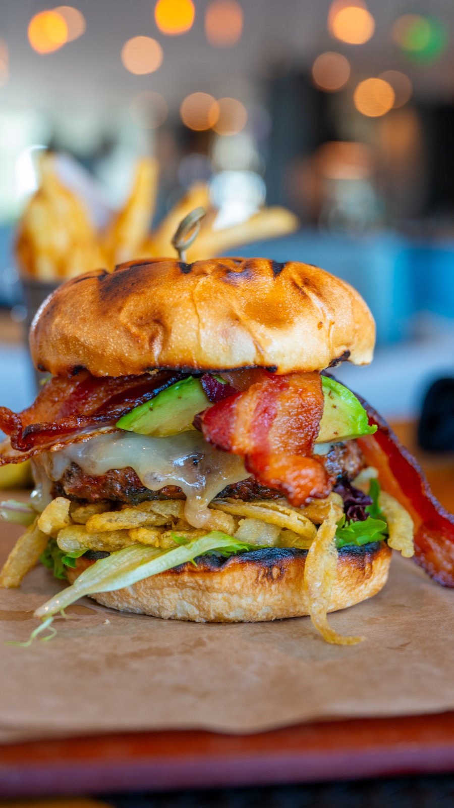 a cheeseburger stacked high with fries, avocado and bacon at BRGR Kitchen + Bar