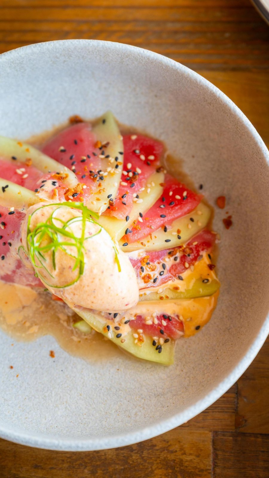 steak tartare arranged like a fan in a white bowl, and topped with a mustard ice cream, at Little Lamb Gastropub in Clearwater